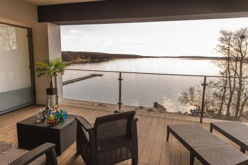 a balcony with a large view of a lake at Apartamenty Boszkowo Horizon Sunset in Boszkowo