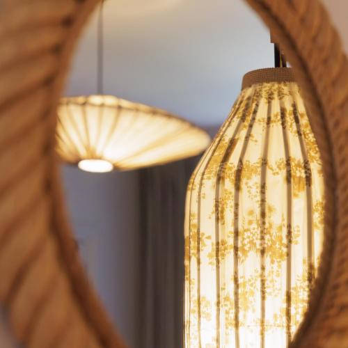 a reflection of a chandelier in a mirror at Domaine de Locguénolé & Spa - Relais & Chateaux in Kervignac