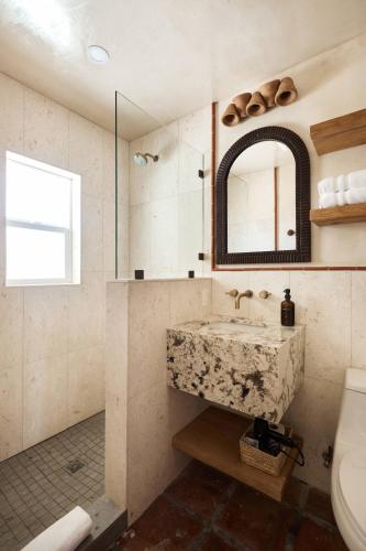 a bathroom with a sink and a mirror at Sand Castle in Imperial Beach