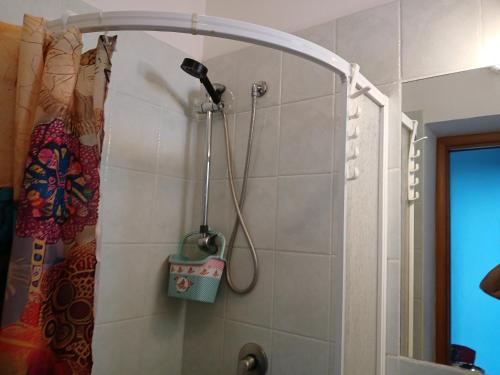 a shower with a blow dryer in a bathroom at La capannina cilento cam 10 in San Marco di Castellabate
