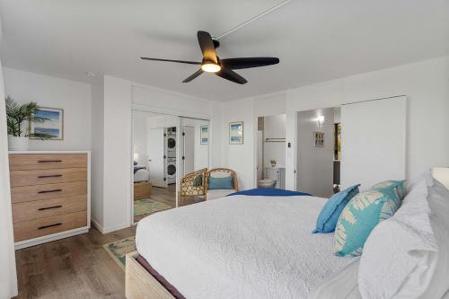 a bedroom with a bed and a ceiling fan at Hale Aloha at Turtle Bay Golf Course in Kahuku