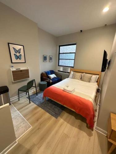 a bedroom with a bed and a living room at Airy Studio South End in Boston