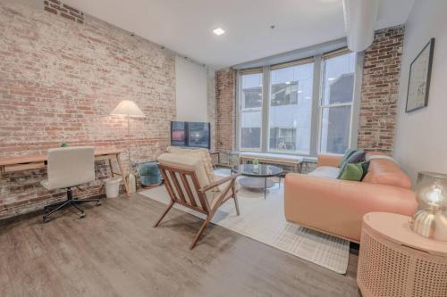 a living room with a brick wall at Downton Boston Luxurious 2 Bed in Boston