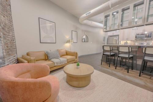 a living room with a couch and chairs and a table at Luxurious Downtown 1 Bedroom in Boston