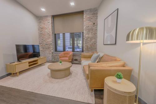 a living room with a couch and a tv at Luxurious Downtown 1 Bedroom in Boston
