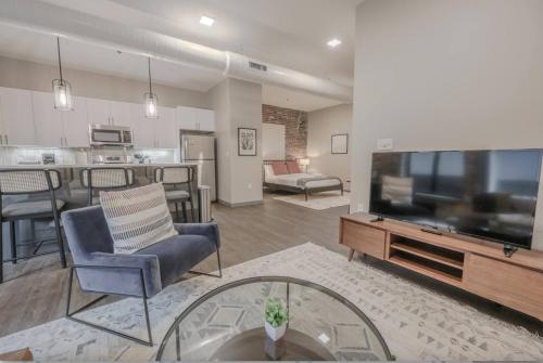 a living room with a large flat screen tv at Charming and Chic Studio Apt in Boston