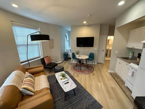 a living room with a couch and a table at Modern studio apartment in Boston