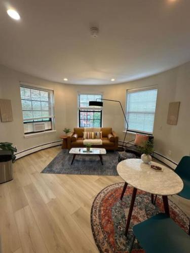a living room with a couch and a table at Modern studio apartment in Boston