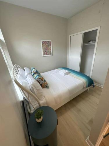 a small bedroom with a bed and a table at Modern studio apartment in Boston