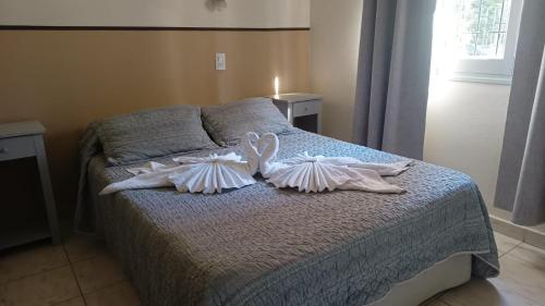 a bedroom with a bed with two pillows on it at Hotel Nuevo Fatica in Villa Carlos Paz