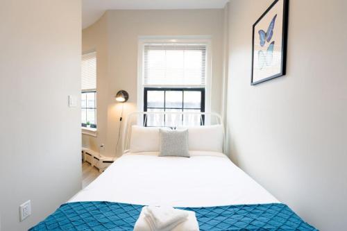a small bedroom with a bed and a window at Spacious and Bright Studio in Boston
