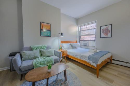 a living room with a bed and a couch at Modern South End Studio Apt in Boston