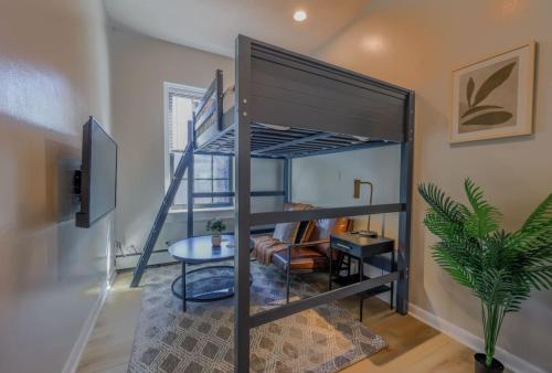 a bunk bed in a room with a table at Cozy Studio South End in Boston