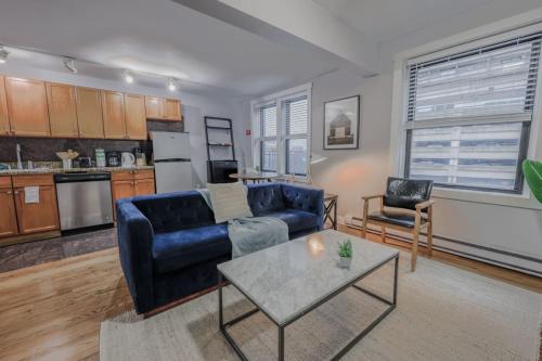 a living room with a couch and a table at Theater District Cozy 1 BR in Boston