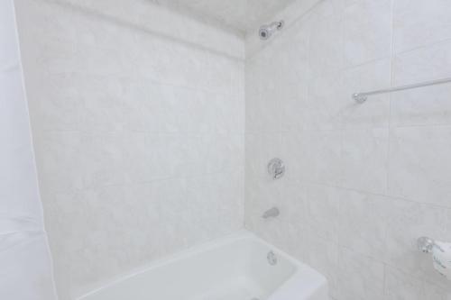 a white bathroom with a shower and a toilet at Theater District Cozy 1 BR in Boston
