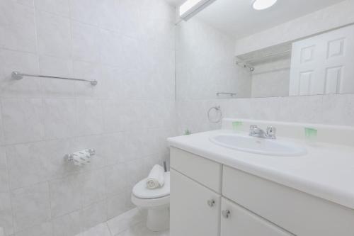 a white bathroom with a sink and a toilet at Theater District Cozy 1 BR in Boston