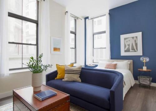 a blue room with a bed and a blue couch at Pet Friendly Studio Walk to MGH in Boston