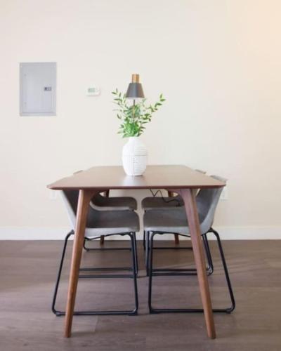 a wooden table with a vase with a plant on it at Pet Friendly Studio Walk to MGH in Boston