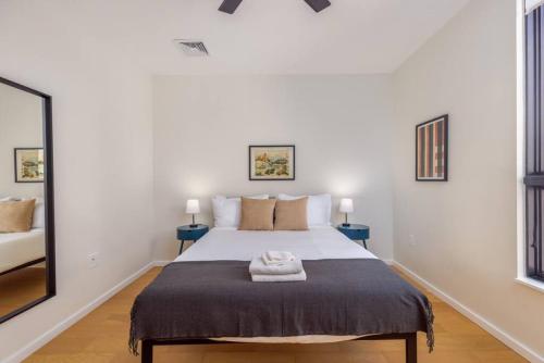 a bedroom with a large bed with two blue tables at New Gorgeous 2Br Mission Hill in Boston