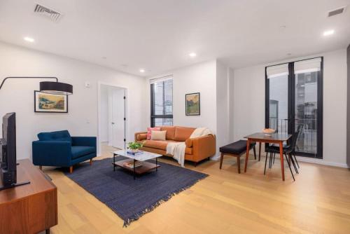 a living room with a couch and a table at New Gorgeous 2Br Mission Hill in Boston