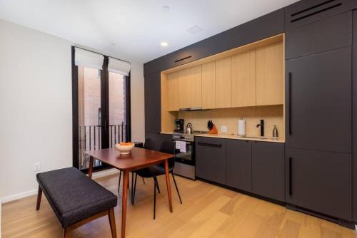 a kitchen with a wooden table and a dining room at New Gorgeous 2Br Mission Hill in Boston