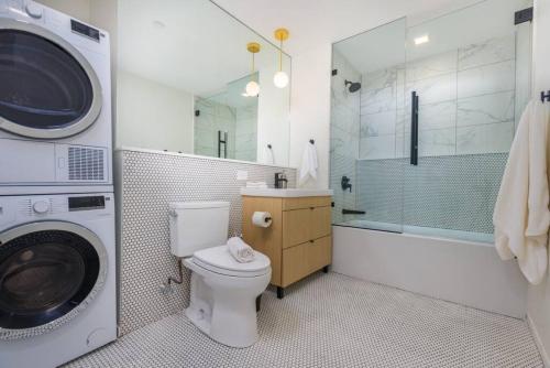 a bathroom with a washing machine and a toilet at New Gorgeous 2Br Mission Hill in Boston