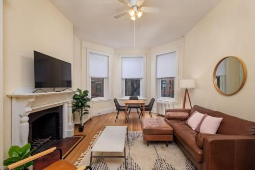 a living room with a couch and a fireplace at Cozy Back Bay 1 Bed 1 Bath in Boston