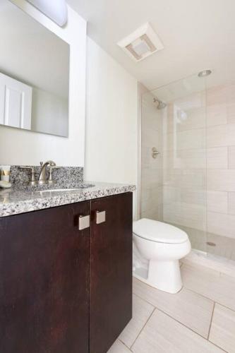 a bathroom with a toilet and a sink and a shower at Bold and Spacious 2 Bed in Boston Financial District in Boston