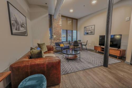 a living room with a couch and a tv at Classic and Chic Apartment 1 Bedroom in Boston