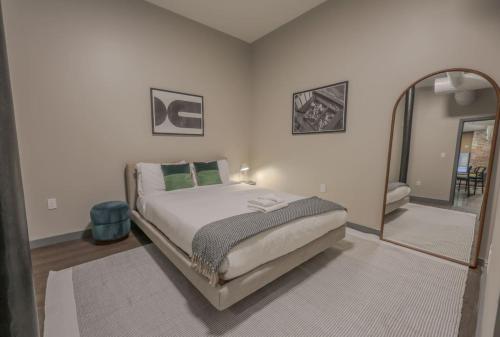 a bedroom with a bed and a large mirror at Classic and Chic Apartment 1 Bedroom in Boston