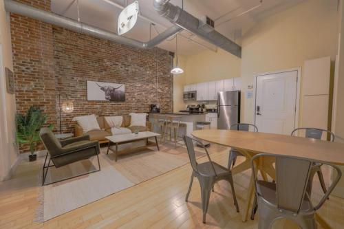 a kitchen and living room with a brick wall at Stylish Exposed Brick 3 Bedroom in Boston