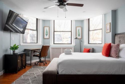 a bedroom with a bed and a desk with a ceiling fan at Cozy Back Bay Studio and Close to Fenway in Boston