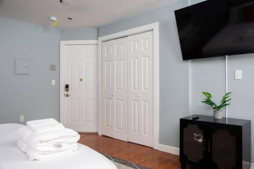 a bedroom with a bed and a flat screen tv at Cozy Back Bay Studio and Close to Fenway in Boston