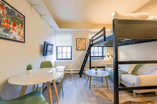 a small apartment with a bunk bed and a dining room at Unique South End Studio in Boston