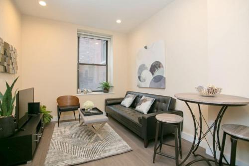 a living room with a couch and a table at Newly Designed Loft - Fast Wifi - Pet Friendly in Boston
