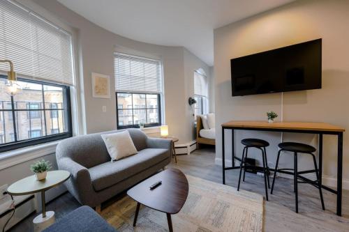 a living room with a couch and a table at Spacious Studio Prudential Area in Boston