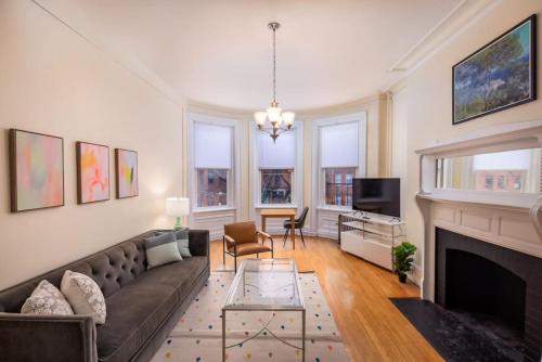 a living room with a couch and a fireplace at Beautiful Newbury St 1 Bedroom unit in Boston
