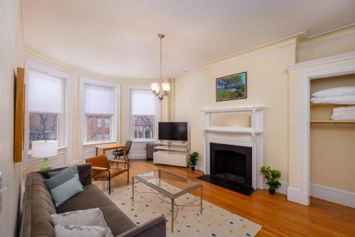 a living room with a couch and a fireplace at Beautiful Newbury St 1 Bedroom unit in Boston