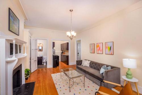a living room with a couch and a fireplace at Beautiful Newbury St 1 Bedroom unit in Boston