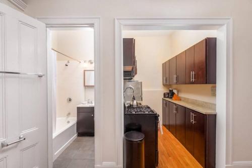 a kitchen with a sink and a stove in it at Beautiful Newbury St 1 Bedroom unit in Boston
