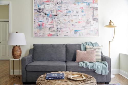 a living room with a gray couch and a table at Wonderful FIDI 2br with Keyless Entry in Boston