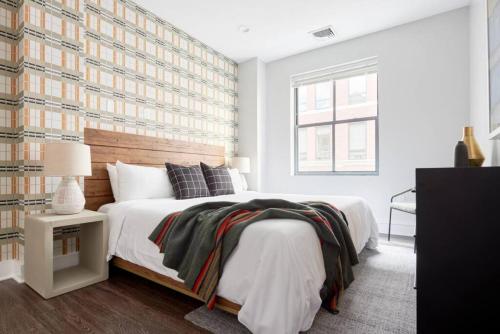 a bedroom with a large bed with a wooden headboard at Spacious 1br In Boston FIDI Close to T in Boston