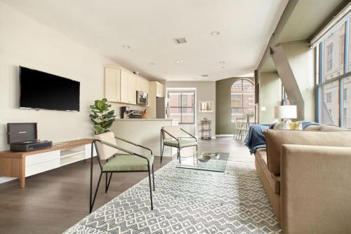 a living room with a couch and a tv at Luxurious 1BR in FIDI Boston Close to Everything in Boston