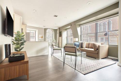 a living room with a couch and a table at Luxurious 1BR in FIDI Boston Close to Everything in Boston