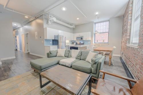 a living room with a couch and a table at Lavishly Designed Home With Office Close to T in Boston