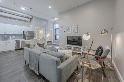 a living room with a couch and a table and a kitchen at Pet Friendly Downtown Boston Elevator Washer Dryer in Boston
