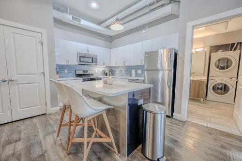 a kitchen with a table and a refrigerator at Pet Friendly Downtown Boston Elevator Washer Dryer in Boston