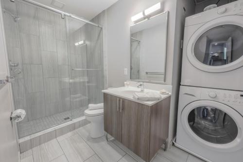 a bathroom with a sink and a washing machine at Pet Friendly Downtown Boston Elevator Washer Dryer in Boston