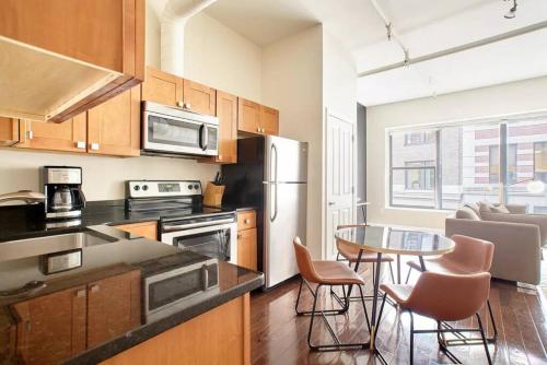 a kitchen with a table and a dining room at 2br 2ba FIDI Apt Keyless Entry Walk anywhere in Boston