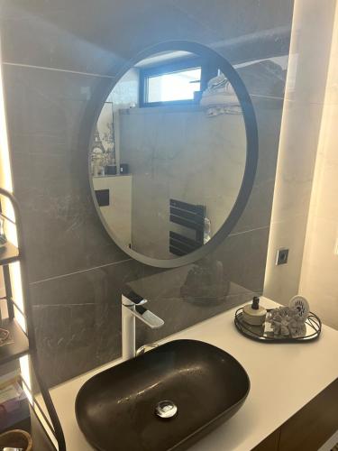 a bathroom with a black sink and a mirror at Faber Penthouse in Bad Oeynhausen